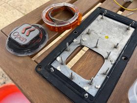 The disassembled front plate, button and light ring. The dirt is very visible - it's caked all around the button fixture .